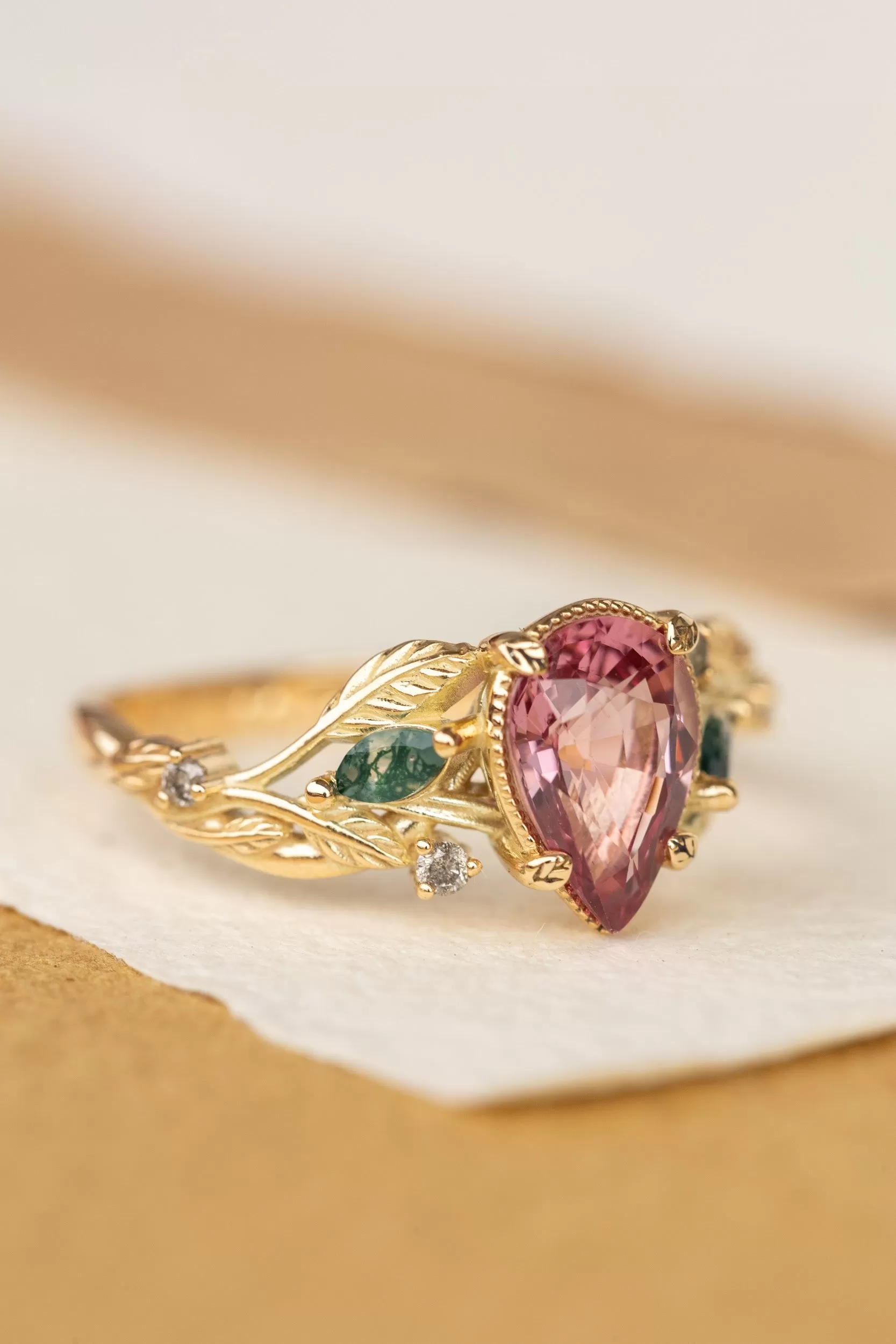 Pink spinel nature themed engagement ring with moss agates and salt and pepper diamonds / Patricia